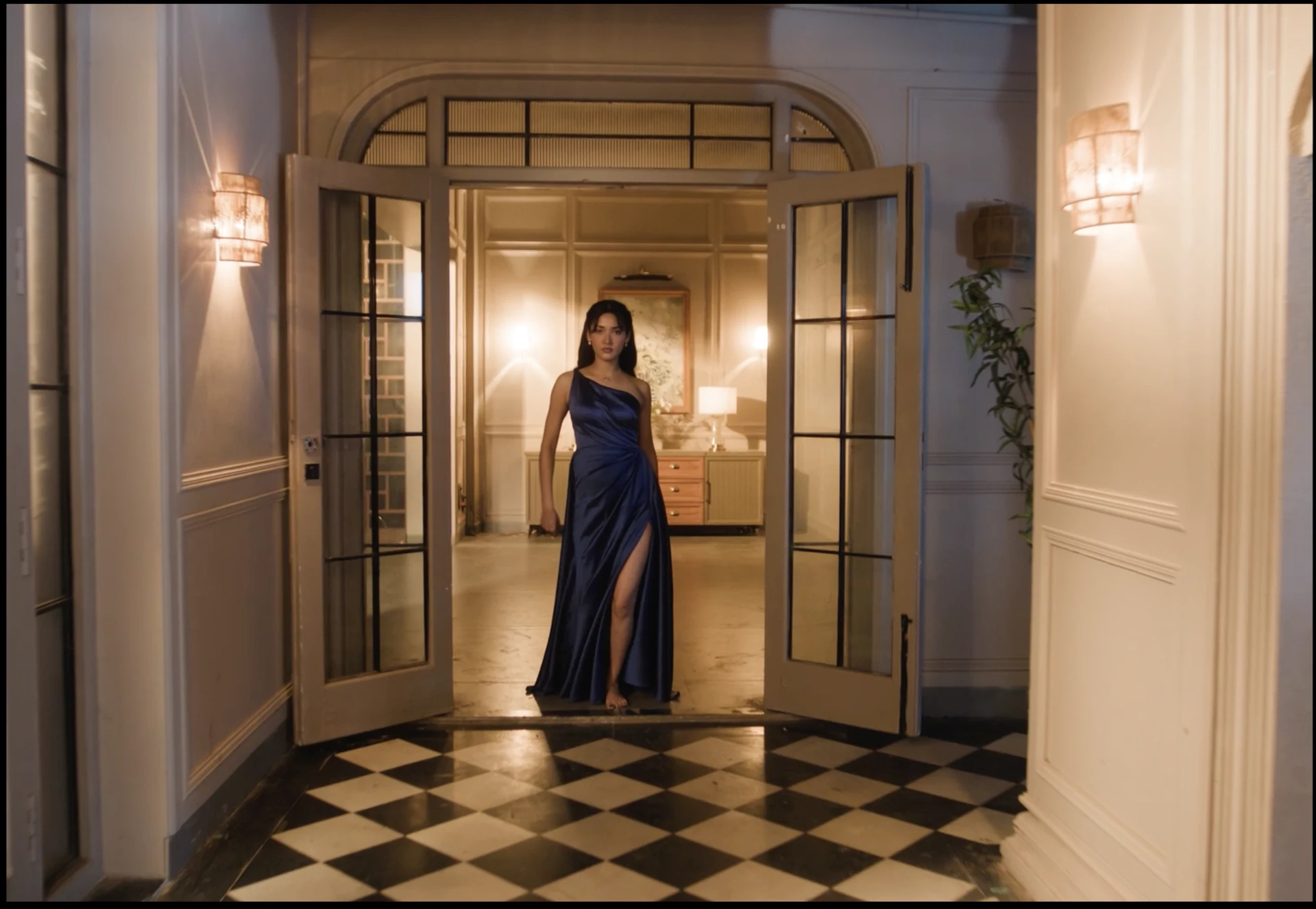 Woman in a blue gown standing in a warmly lit doorway.